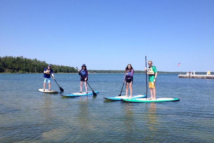 A group of people on SUPs